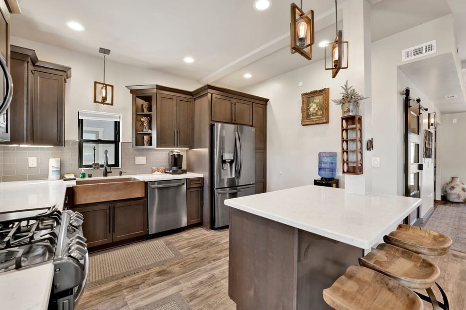 Fully equipped cabin kitchen with ample cabinetry, stove, fridge, microwave, and coffee maker—perfect for cooking meals, morning coffee, and feeling right at home on your stay.