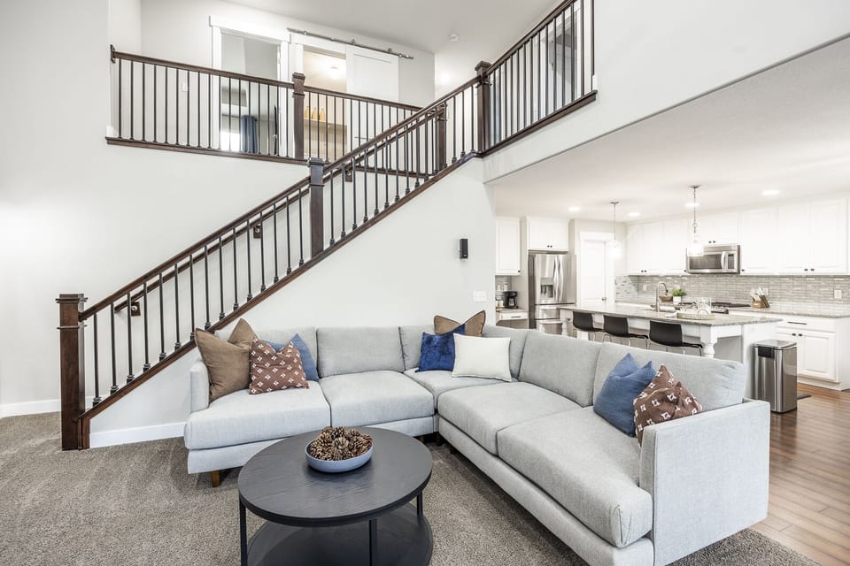 The main floor living room houses a 65-inch tv with an open floor plan