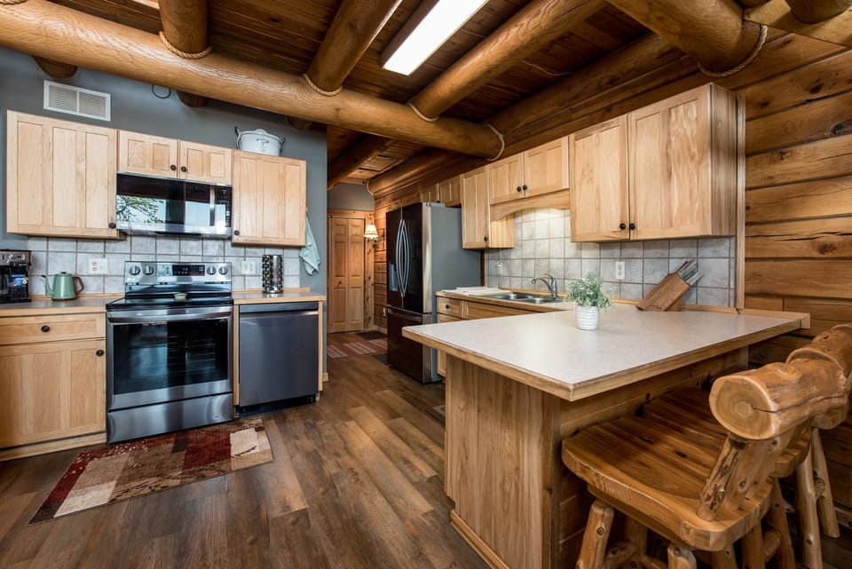 Fully stocked and updated kitchen with a 3 seat eat-in kitchen island.