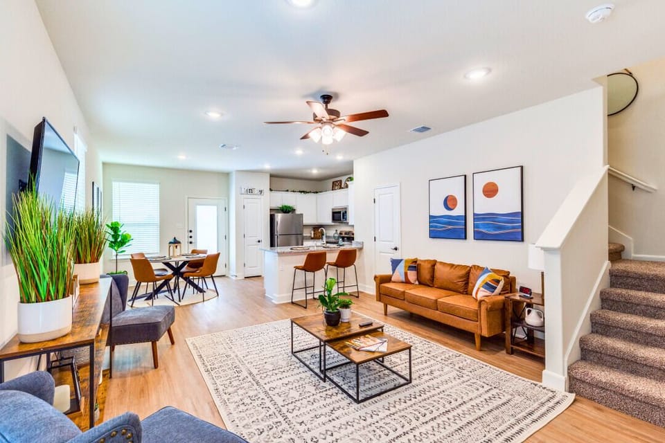 Step into a sunlit living room featuring a plush sofa, smart TV, and chic décor—a cozy spot to relax, binge your favorite shows, or enjoy time with friends and family.