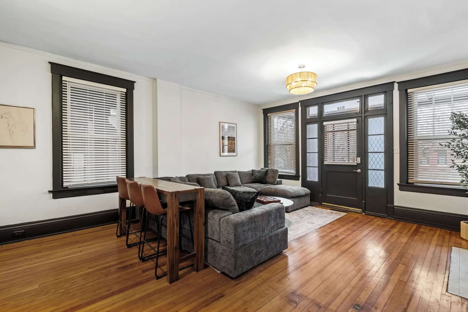 Living Room: Relax in our bright living space, featuring a comfy sofa, wooden floors, and plenty of natural light to make you feel right at home.