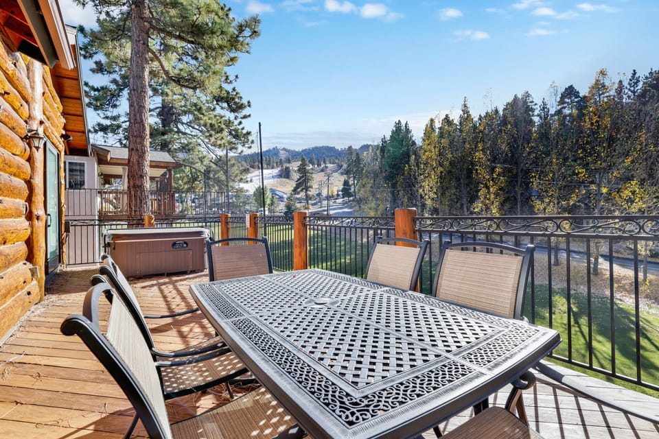 Private outdoor hot tub, surrounded by tall pines, perfect for relaxing under the trees after a day of adventure—enjoy peaceful forest views, fresh air, and a truly rejuvenating stay.