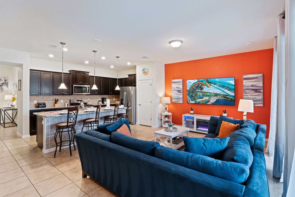 Discover a colorful haven in our living room, designed for playfulness and relaxation. With ample seating for watching shows, movies, games, and more, it's the perfect gateway to easy pool access for added enjoyment.