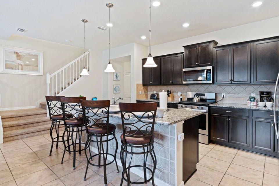 Full equipped kitchen- fronting the counter table to grab a snack or a quick coffee break
