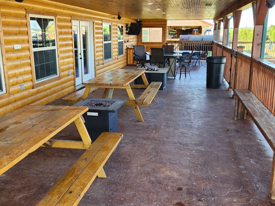 Community pool shaded patio area with picnic tables for lunch or snack time.