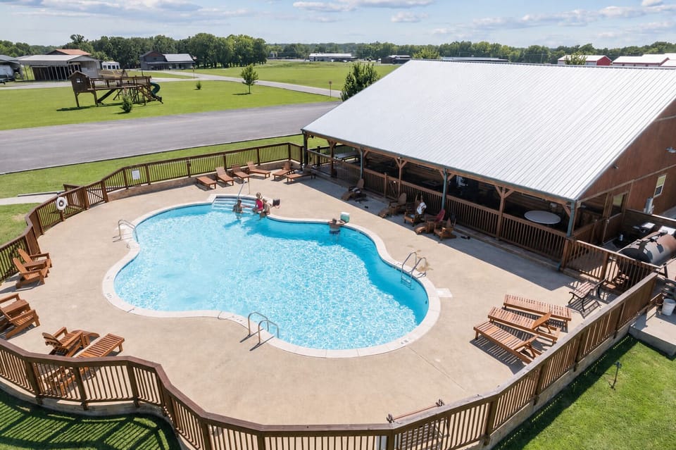 Community pool with shaded patio area, and kids playground across the street.