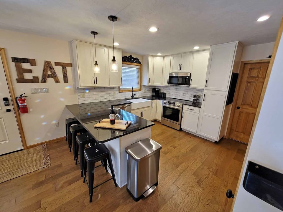 The kitchen features shaker cabinets, real granite counters, and new appliances.
