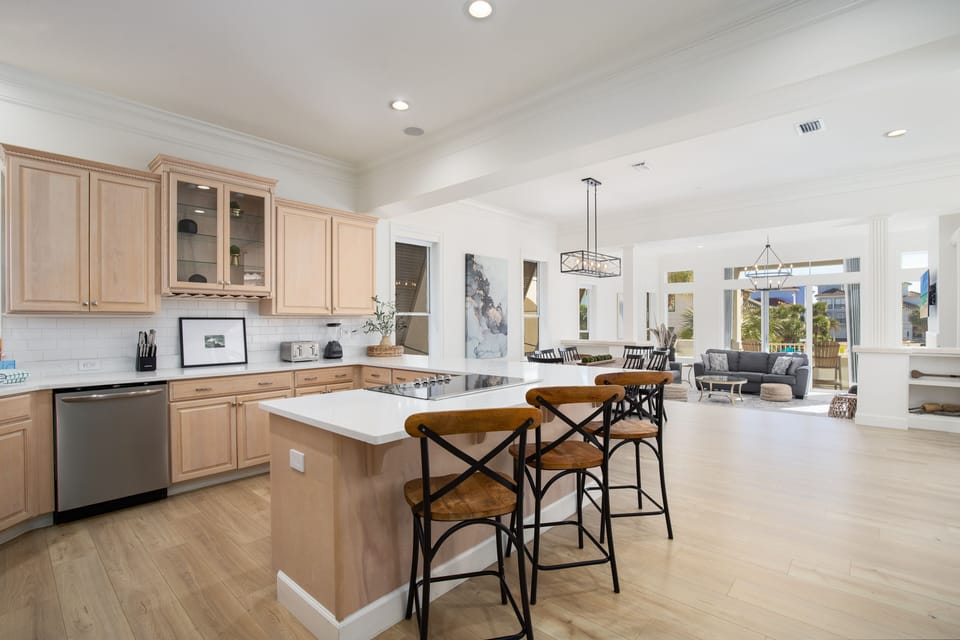 You'll love cooking in this spacious kitchen with gleaming countertops and island seating that flows seamlessly into the bright dining area.