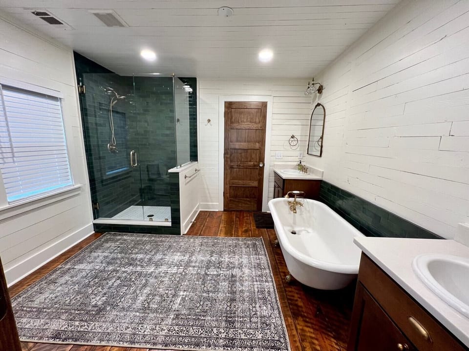 Main bathroom. 2 separate vanities, toilet, standing shower & clawfoot tub. 