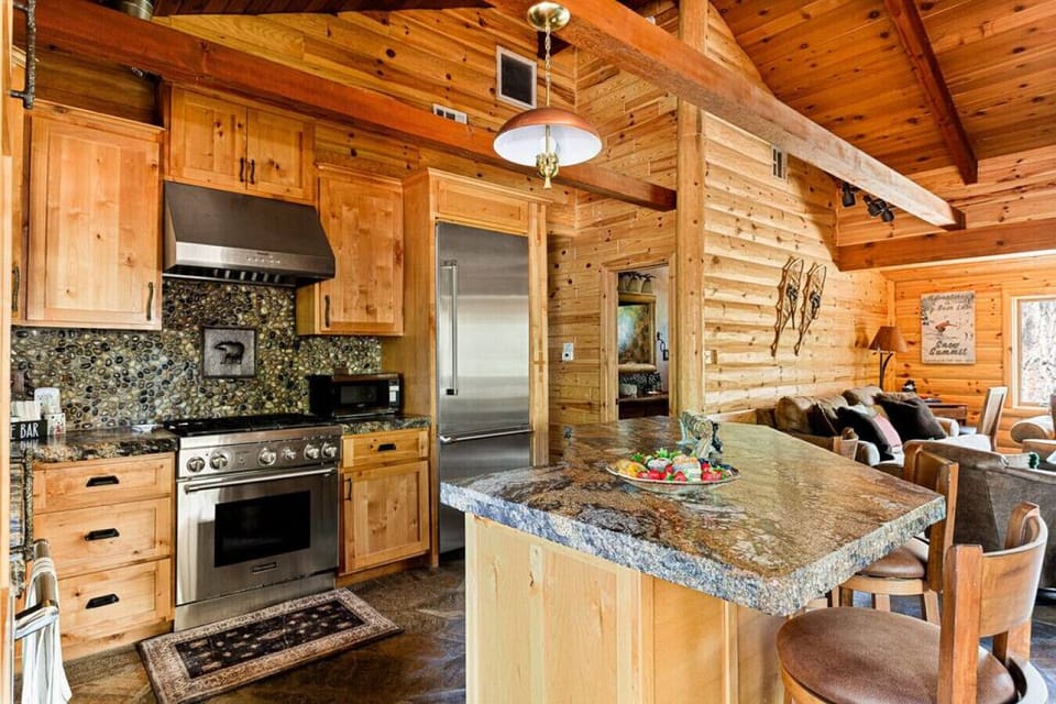 Impressive kitchen with leathered granite counters and kitchen Island with seating.