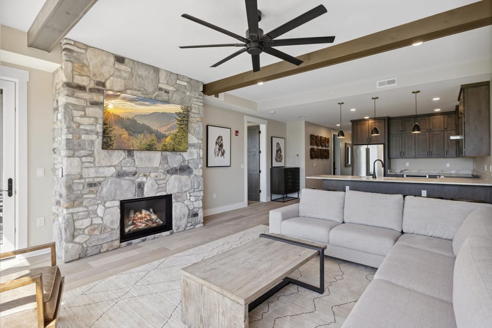 Spacious Living Room - Spacious and Scenic Living Room with Stone Fireplace, Floor to Ceiling Windows with Smoky Mountain View, Smart TV's and WiFi throughout vacation condo