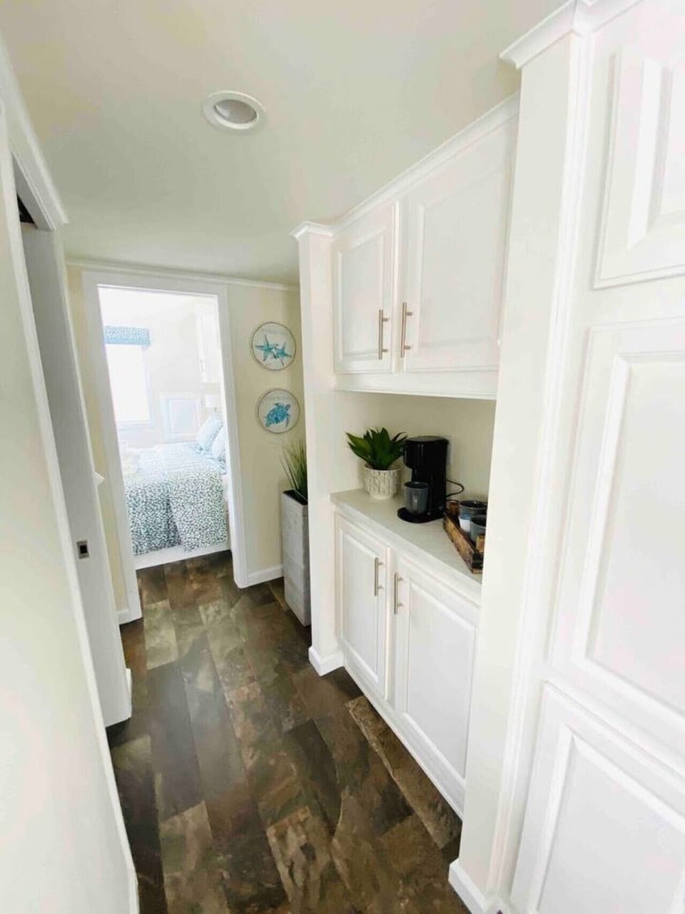 Hallway  leading to the bathroom and loft, to the left, and the main bedroom straight ahead. Coffee bar is on the right ☺️