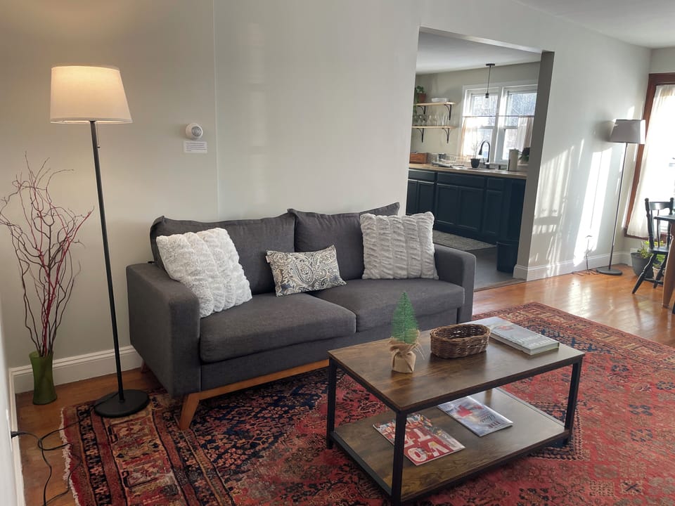 The living room area has a comfortable couch, smart tv, & plenty of board games