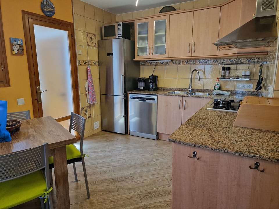 The modern kitchen at House Don Quichotte is fully equipped with all essential appliances and offers plenty of space for holiday cooking.