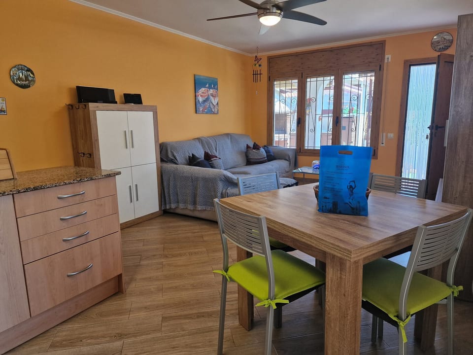 Inviting perspective directly from the modern kitchen of House Don Quichotte across the dining area into the cozy living room.