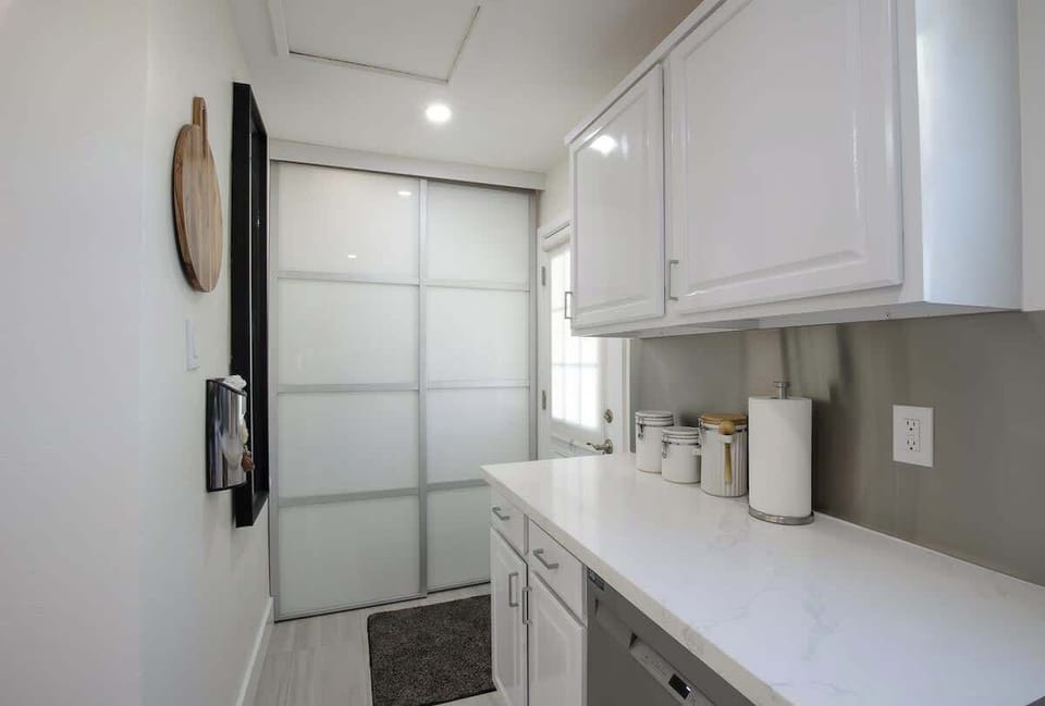 Laundry behind sliding doors. Door to pool