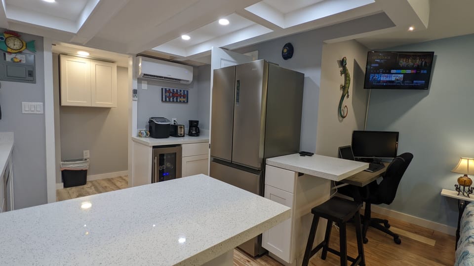 kitchen with full size refrigerator, wine & beverage cooler below appliance area