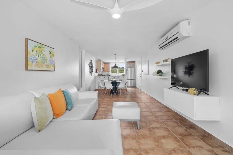The open concept apartment seamlessly connects kitchen, dining and living areas.