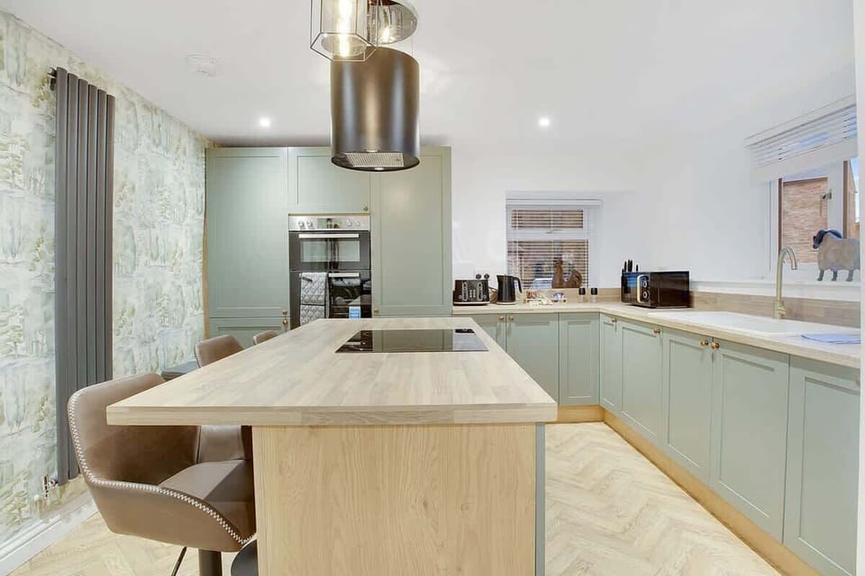 Family-friendly kitchen oasis equipped with all essentials, including a washer & dryer, oven, fridge and full cookware set. Plus, a breakfast counter to ensure everyone feels right at home in this cozy culinary haven.