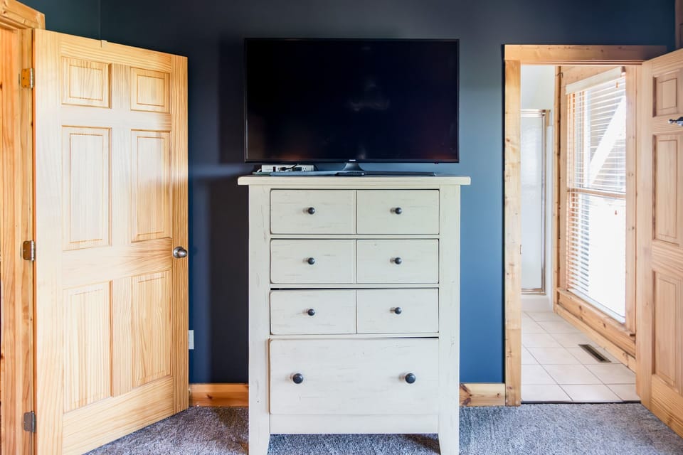 Dresser and Roku TV in primary bedroom