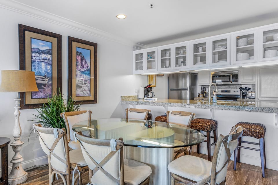 Gather around your elegant glass dining table while savoring morning coffee at the stylish breakfast bar.