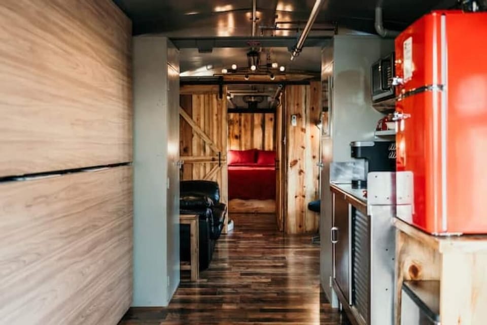 Sliding barn door separates bedroom from living area