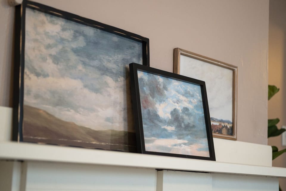 Hanging frames above the fireplace