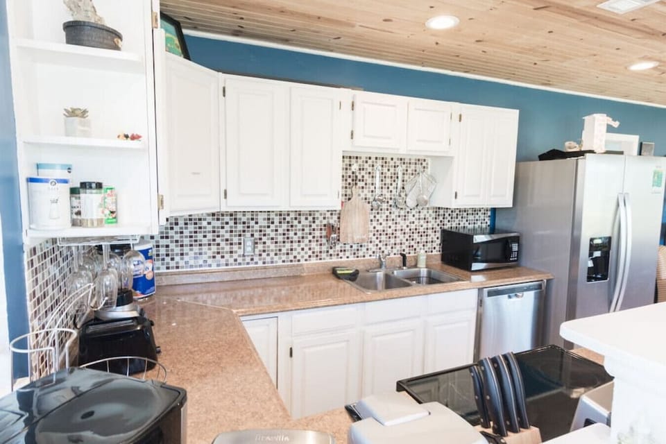 Bright Kitchen Oasis: Whip up culinary delights in this vibrant, spacious kitchen with stylish decor!