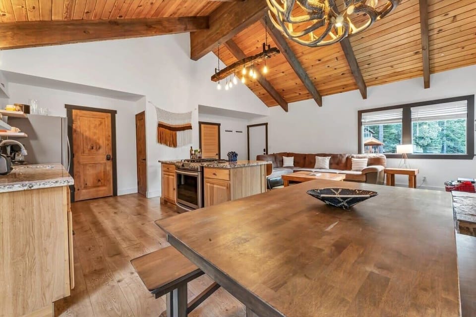 The charming dining room seats six, complemented by three additional stools at the kitchen bar area.