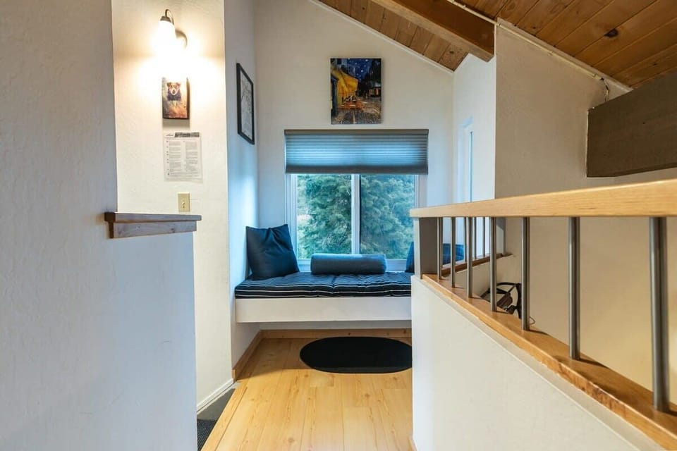 On the upper floor a cozy window seat offers a dreamy spot for reading or enjoying the scenery.