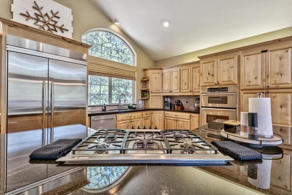 Gas range, kitchen well equipped with bakeware, cookware, dinnerware for preparing and enjoying a holiday meal