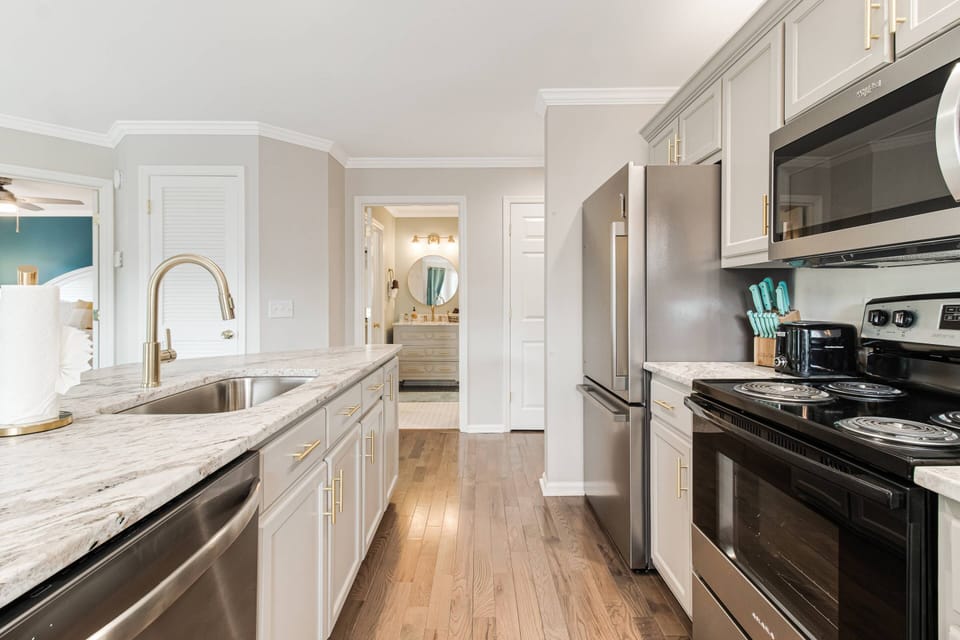 View of Kitchen with one of the 2 bathrooms in the distance