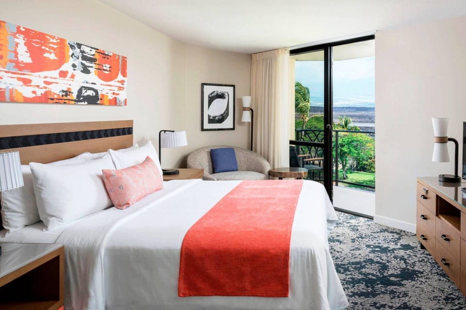 Primary Bedroom features a king bed, door to the balcony, and ensuite bathroom.