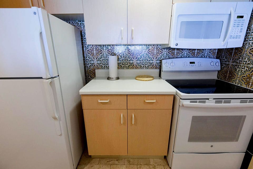 Kitchen complete with Stove, Oven, Microwave, Refrigerator, Dishes and utensils.