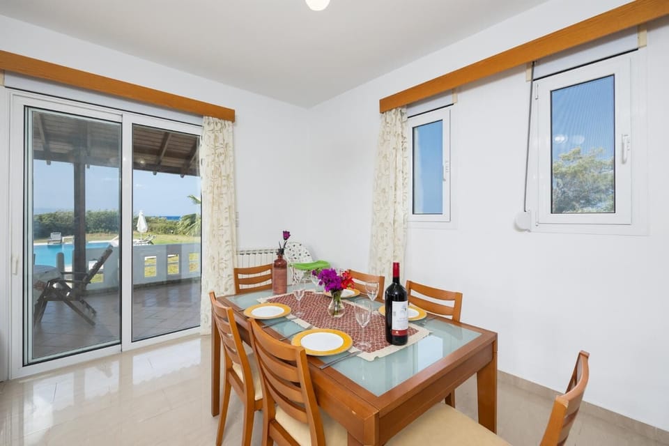 Living room with sofas, dining area, ornamental fireplace, A/C, WiFi internet, and satellite TV