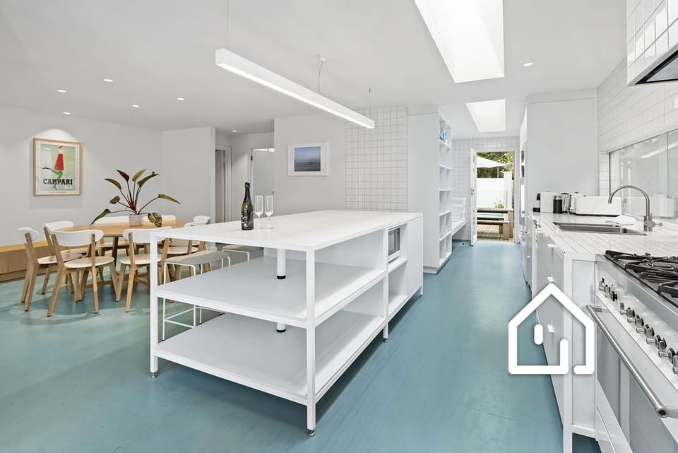 A well-equipped industrial-style kitchen, between the living room and pool area