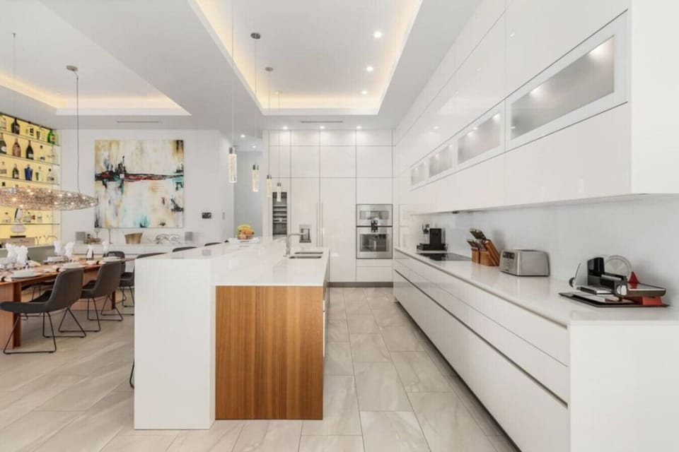 Sleek modern kitchen with high-end appliances and spacious dining area for entertaining.