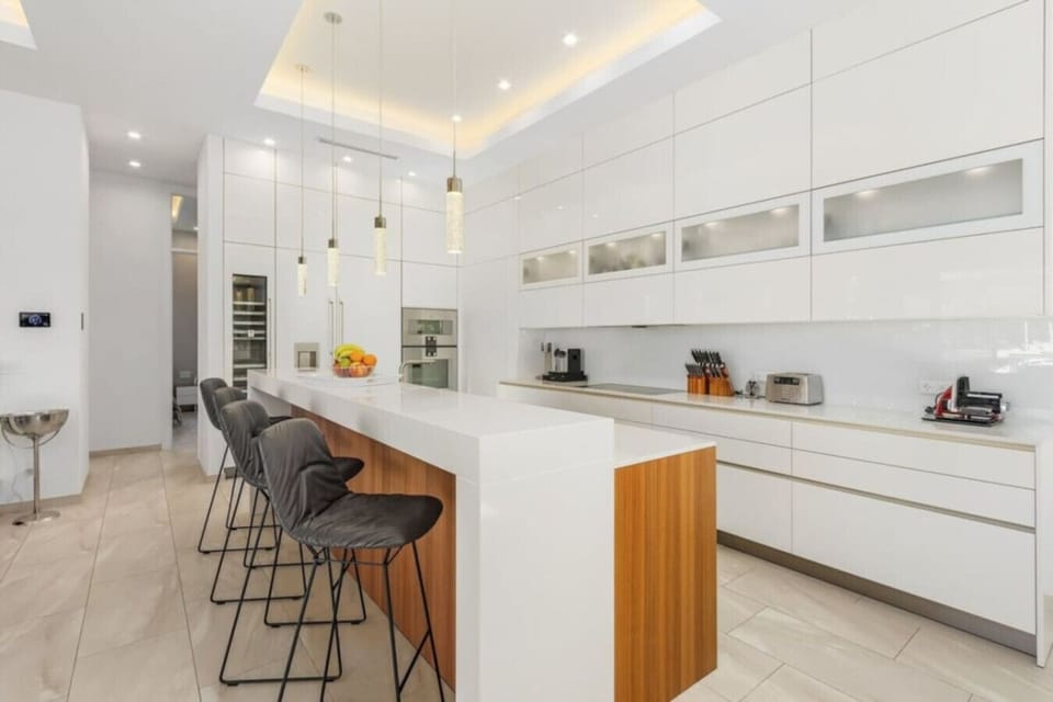 Sleek modern kitchen with high-end appliances and a spacious breakfast bar.