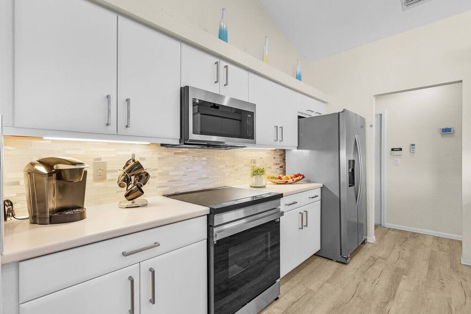 Cook with ease in the updated kitchen featuring stainless steel appliances, sleek cabinetry, and everything needed for home-cooked meals.