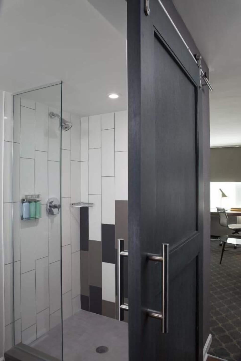Refresh in a sleek walk-in shower with bright tile.