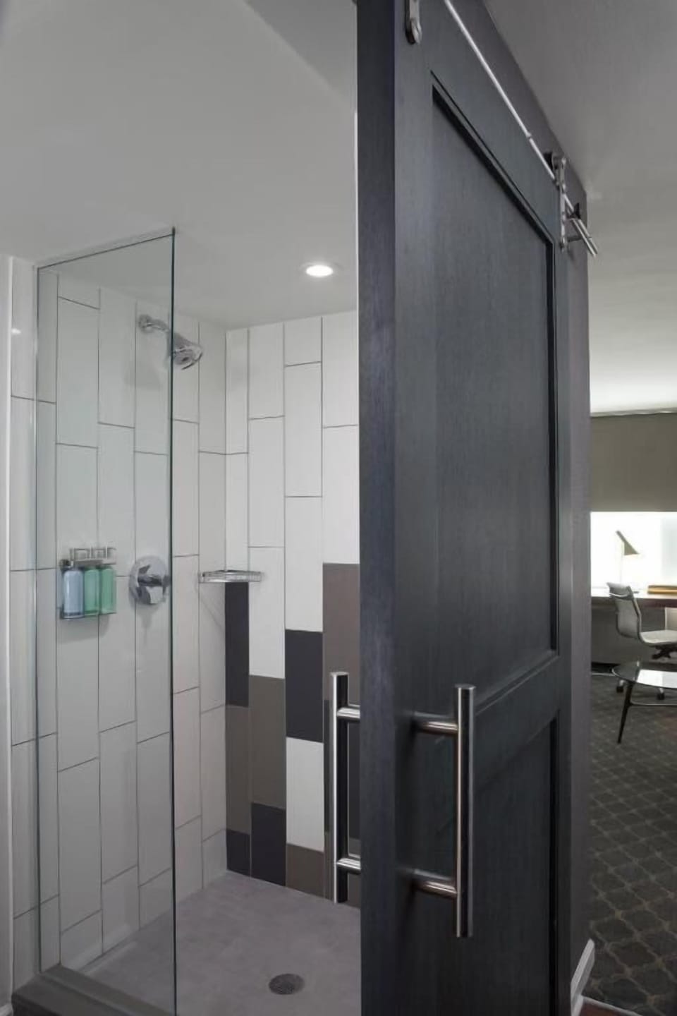 Refresh in a sleek walk-in shower with bright tile.