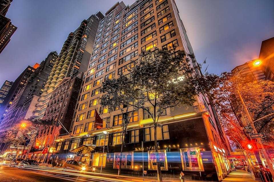 Arrive in style at a glowing city-center high-rise.
