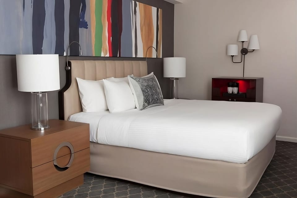 Sink into a cloud-soft bed framed by warm bedside lighting.
