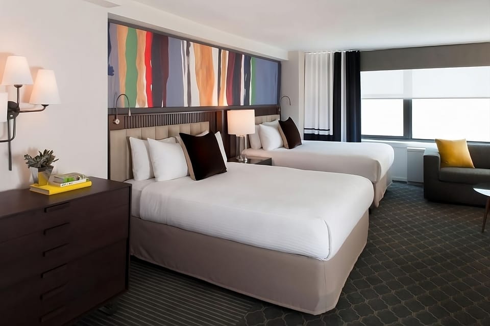 Stretch out in two plush beds beneath bold, modern art.