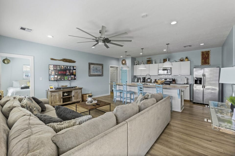 Open living space with cozy seating and a fully equipped modern kitchen.