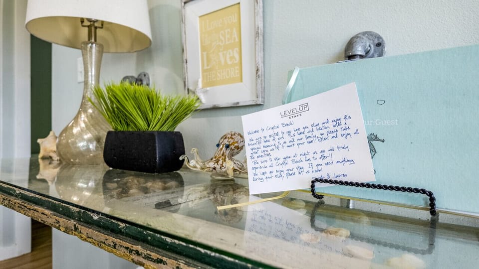 A warm welcome note and decor greet guests at the entryway table.