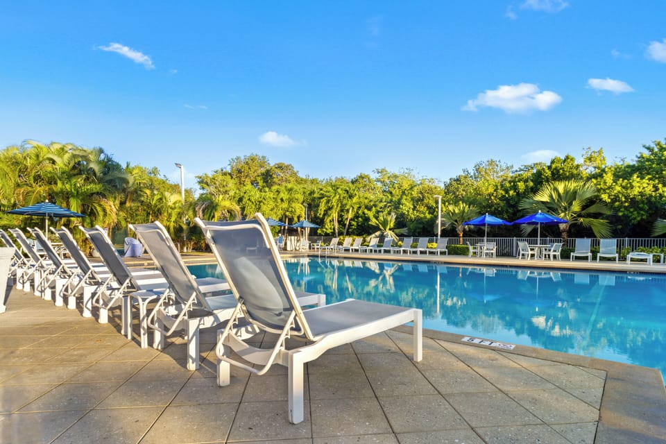 Soak up sunshine from a lounger beside the calm pool.