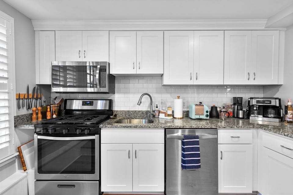Kitchen is equipped with Microwave, gas stove top, oven, and dishwasher. 