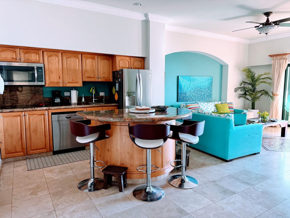 The island bar is a great place to enjoy a quick snack or hang out with the cook