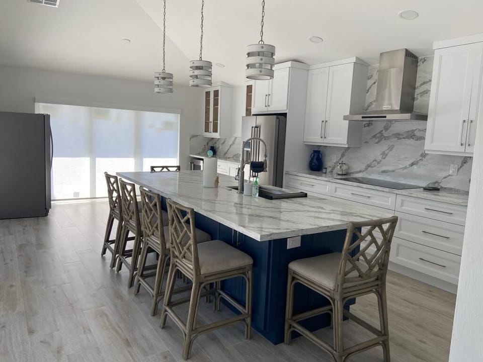 Island view as you enter kitchen.  Rear sliders have view to water. 